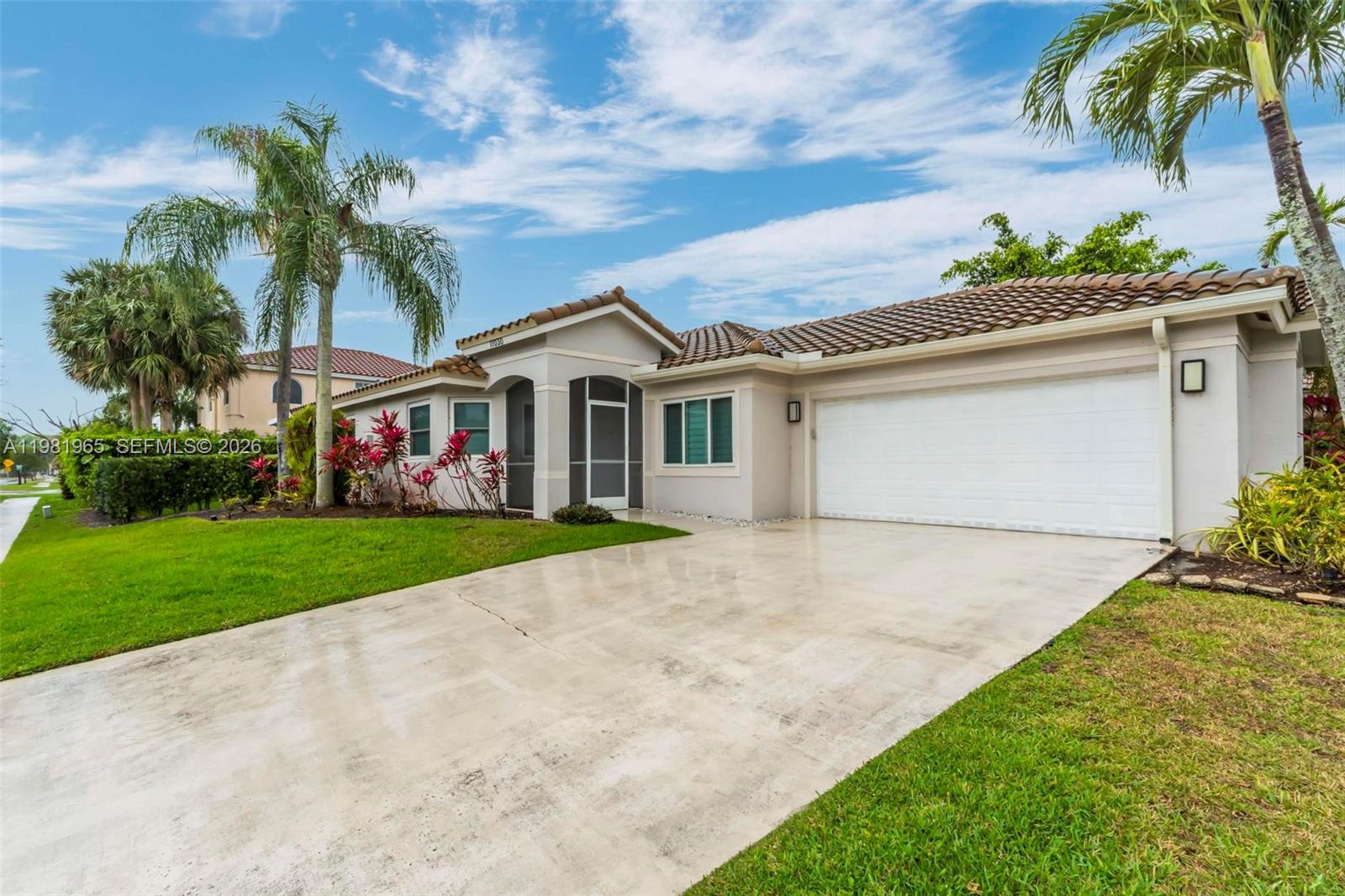 11030 Harbour Springs Circle Boca Raton, FL 33428 - Photo 22 of 39 a front view of house with small garden and palm trees