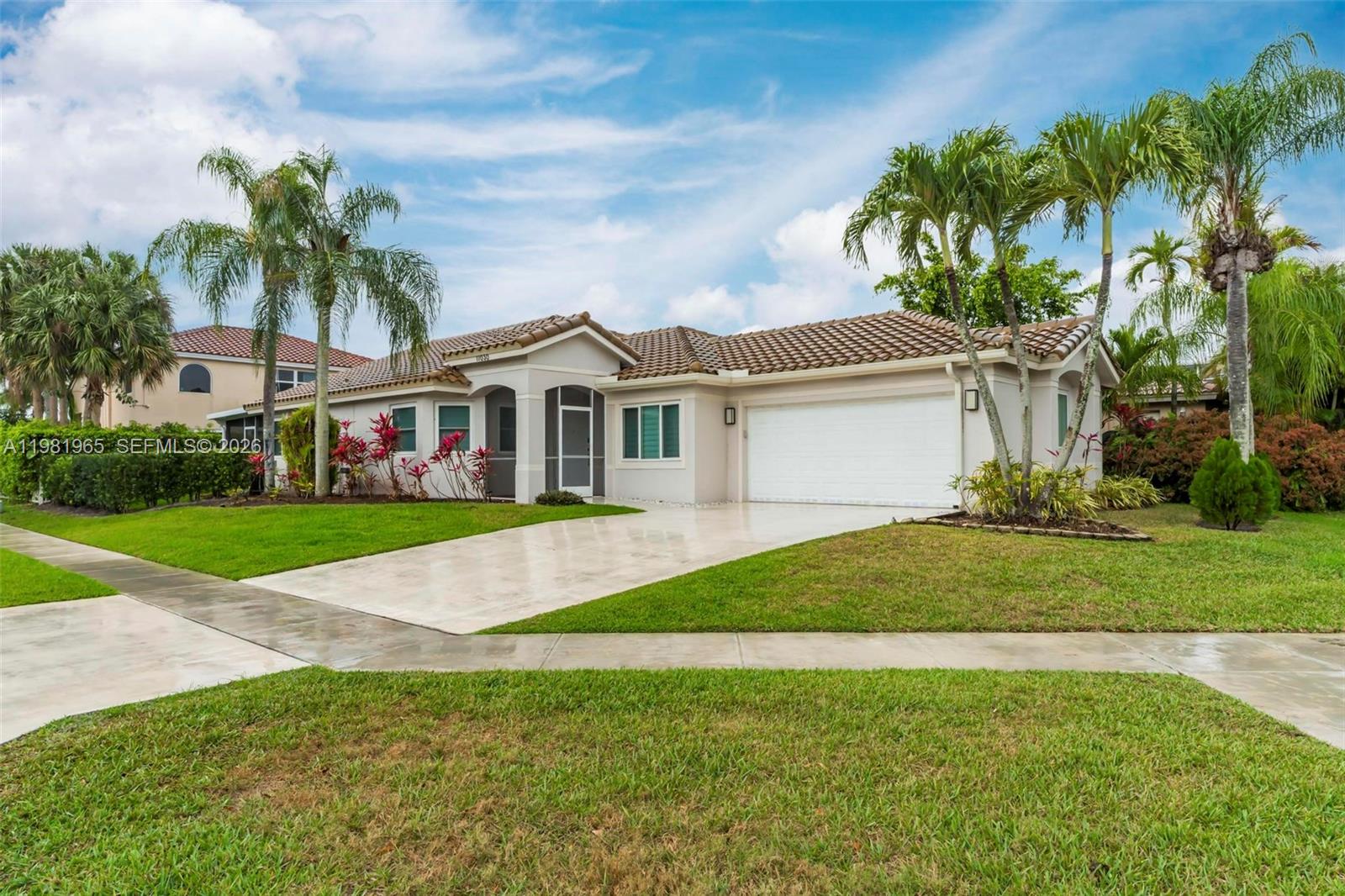 11030 Harbour Springs Circle Boca Raton, FL 33428 - Photo 24 of 39 a front view of house with yard and green space