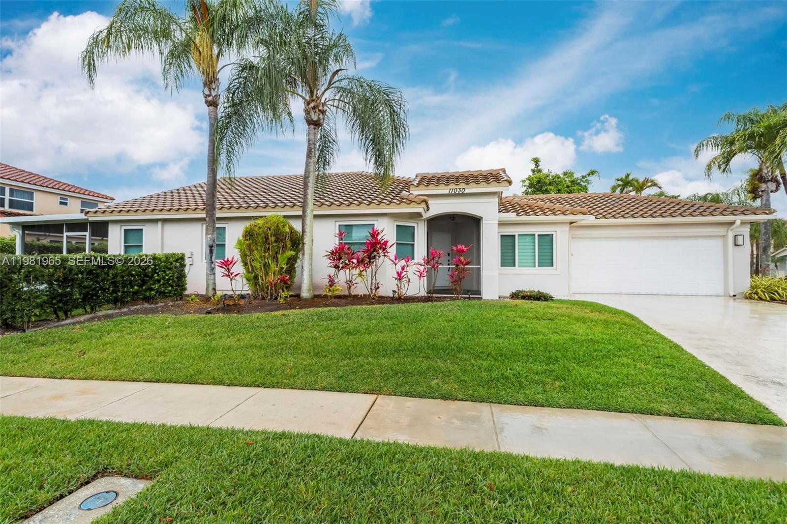 11030 Harbour Springs Circle Boca Raton, FL 33428 - Photo 25 of 39 a front view of a house with garden