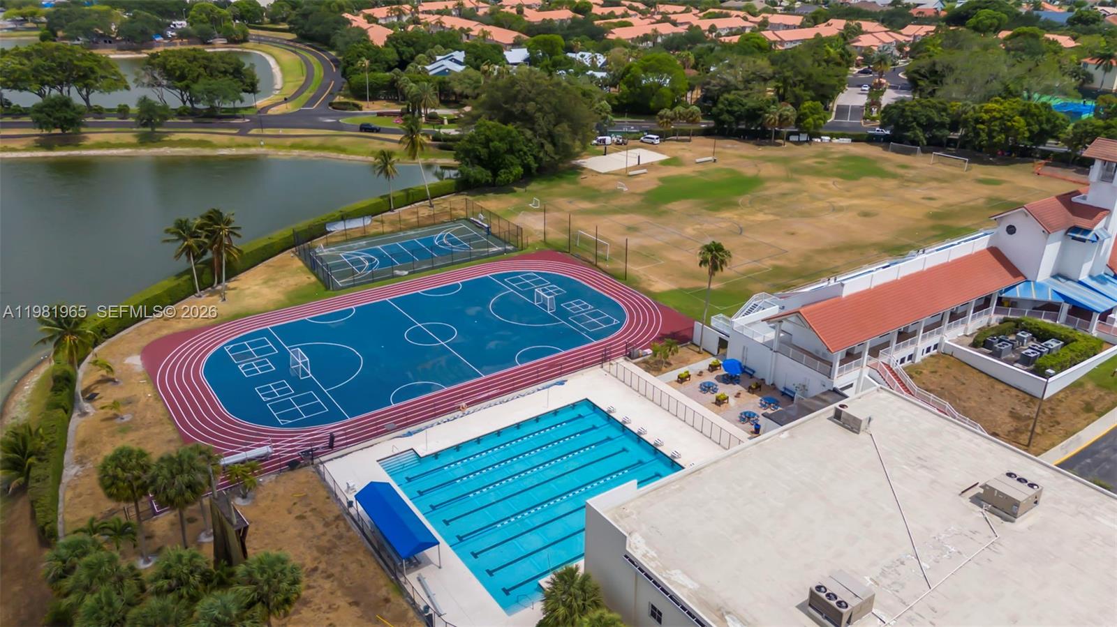 11030 Harbour Springs Circle Boca Raton, FL 33428 - Photo 38 of 39 an aerial view of a house roof deck with couches and wooden floor