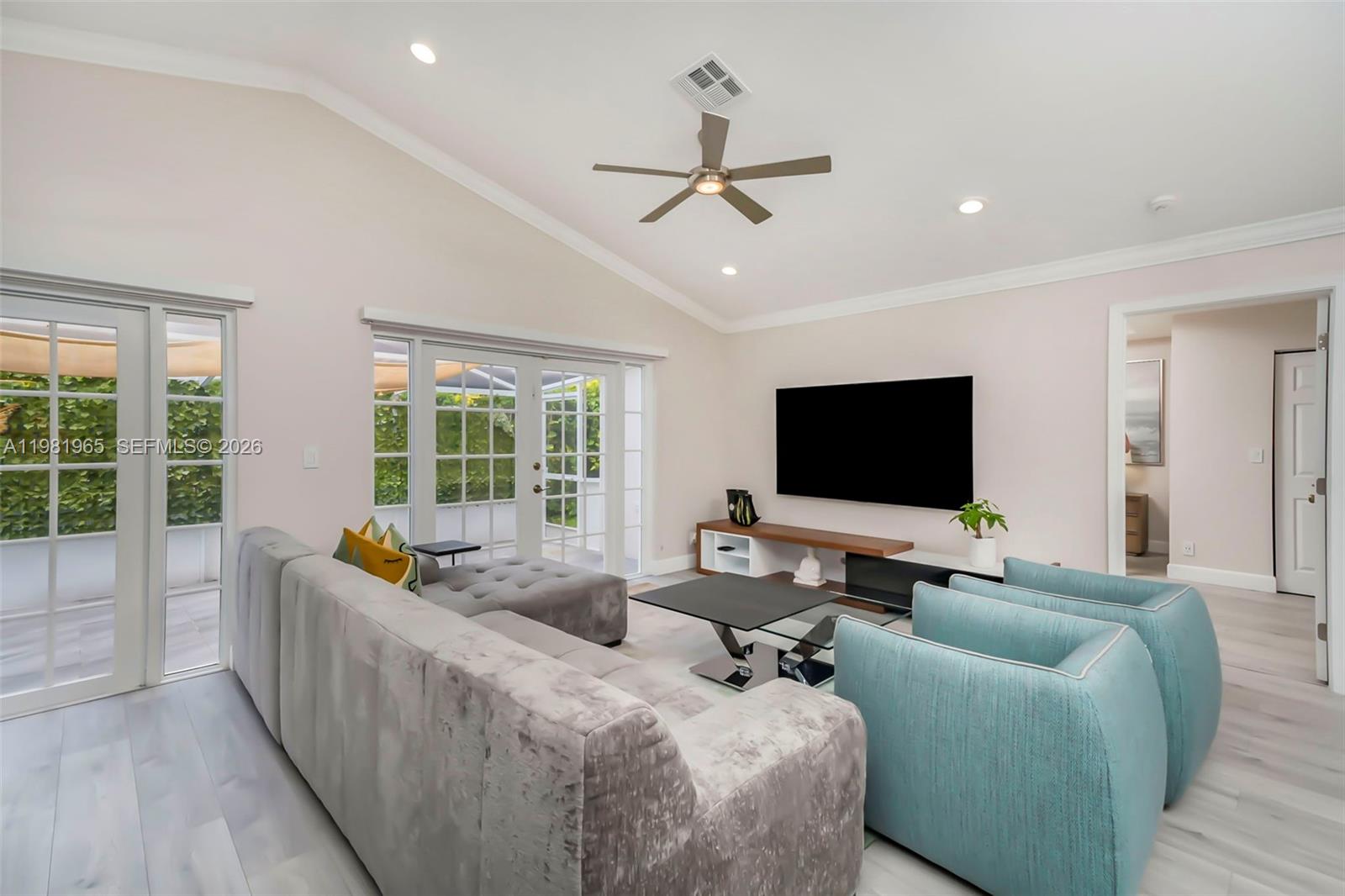 11030 Harbour Springs Circle Boca Raton, FL 33428 - Photo 5 of 39 a living room with furniture and a flat screen tv