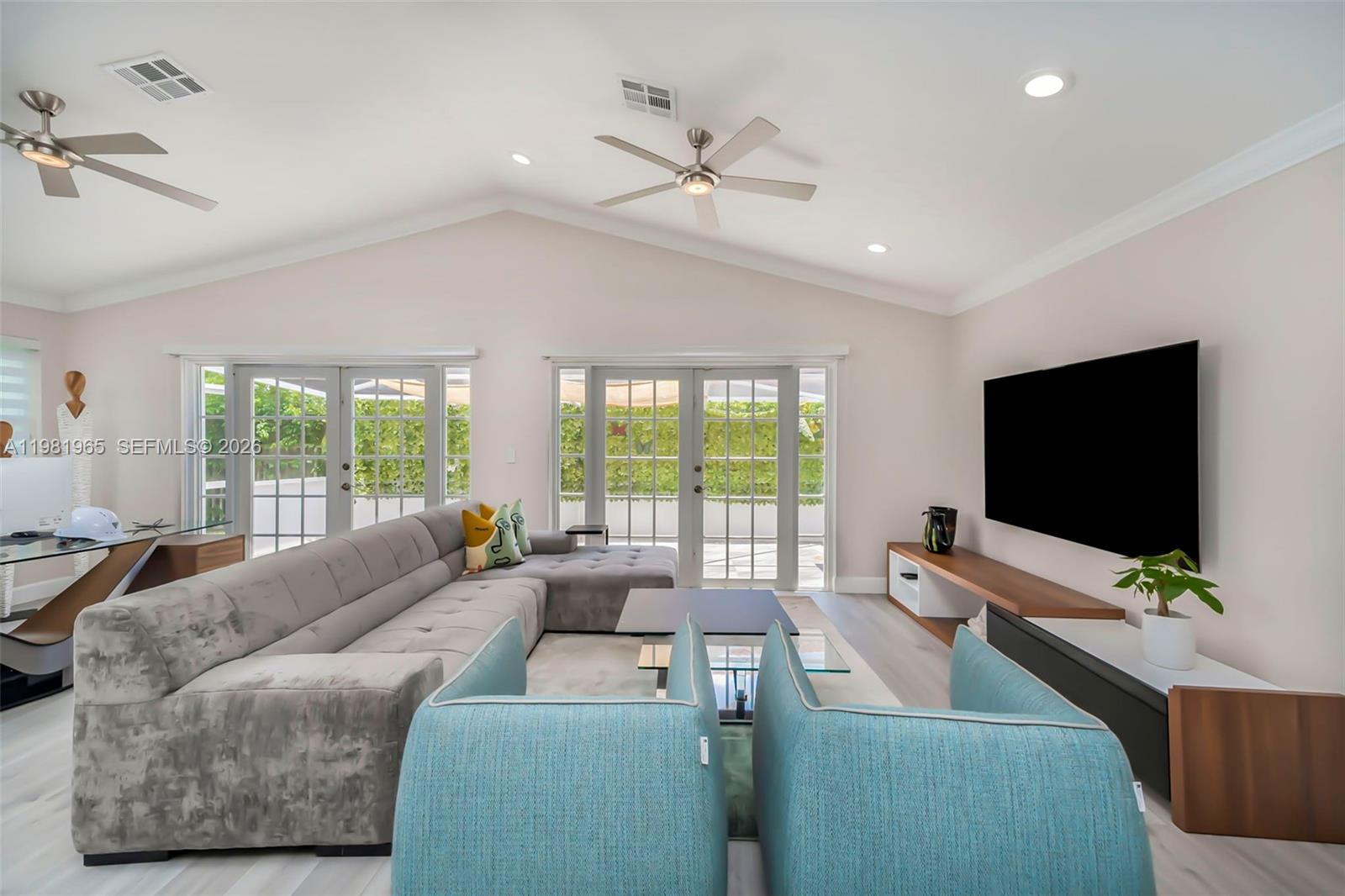 11030 Harbour Springs Circle Boca Raton, FL 33428 - Photo 6 of 39 a living room with furniture and a flat screen tv