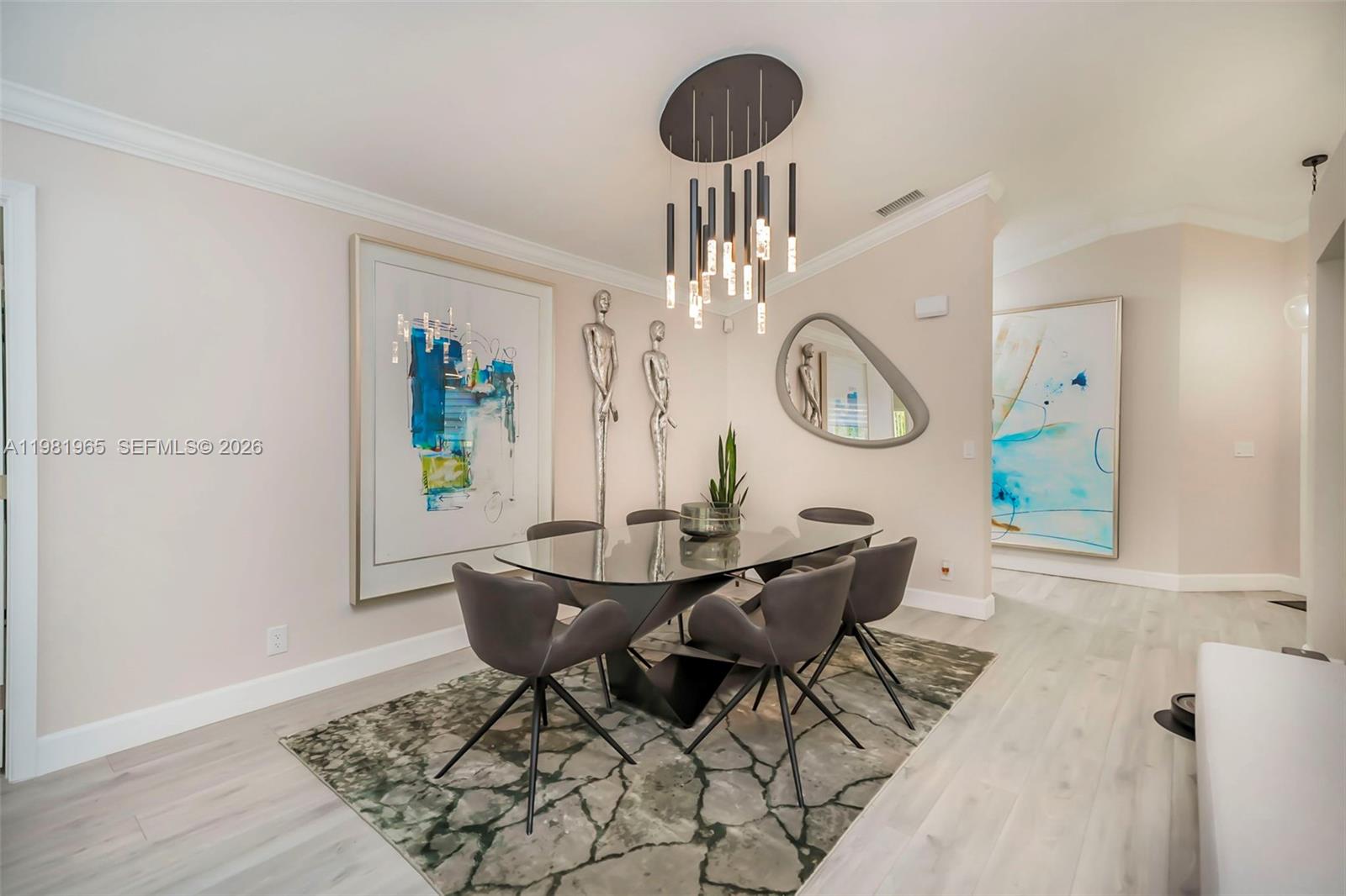 11030 Harbour Springs Circle Boca Raton, FL 33428 - Photo 8 of 39 a view of a dining room with furniture and a chandelier