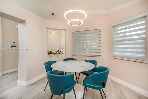 a view of a dining room with furniture window and wooden floor