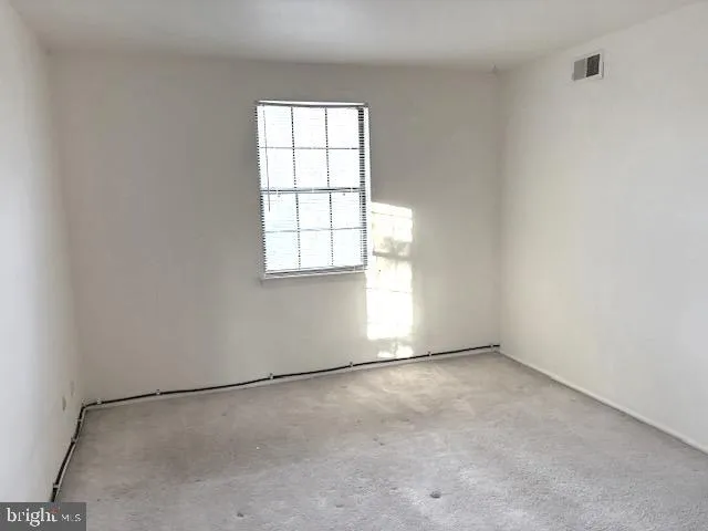 an empty room with a empty space and windows