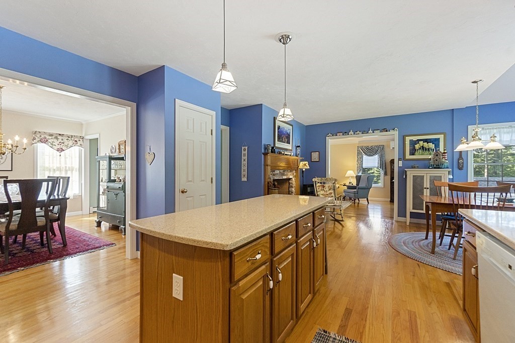 71 Easter Brook Road Lunenburg, MA 01462 - Photo 13 of 33 a view of a dining room and livingroom with furniture wooden floor a chandelier