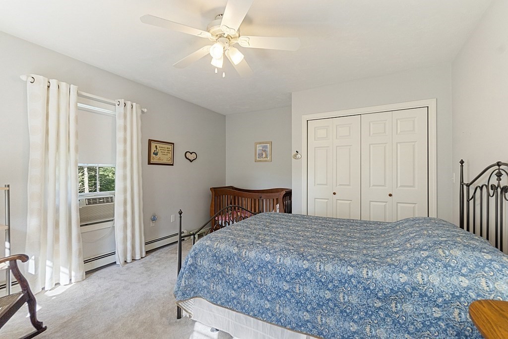 71 Easter Brook Road Lunenburg, MA 01462 - Photo 21 of 33 a bedroom with a bed and a chandelier