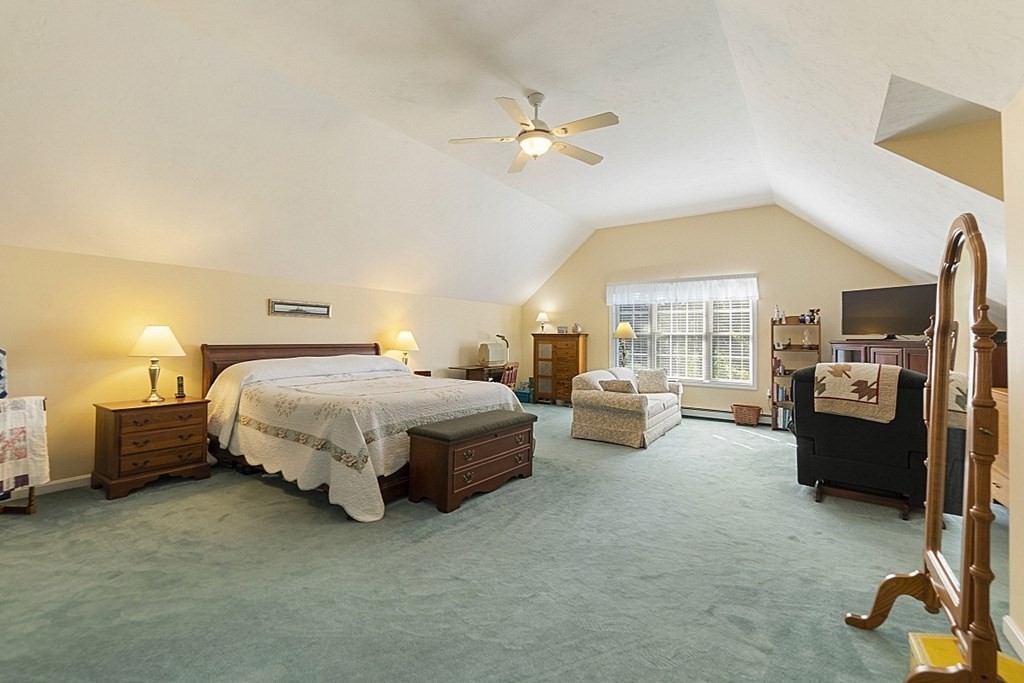 71 Easter Brook Road Lunenburg, MA 01462 - Photo 24 of 33 a spacious bedroom with a bed and a chandelier