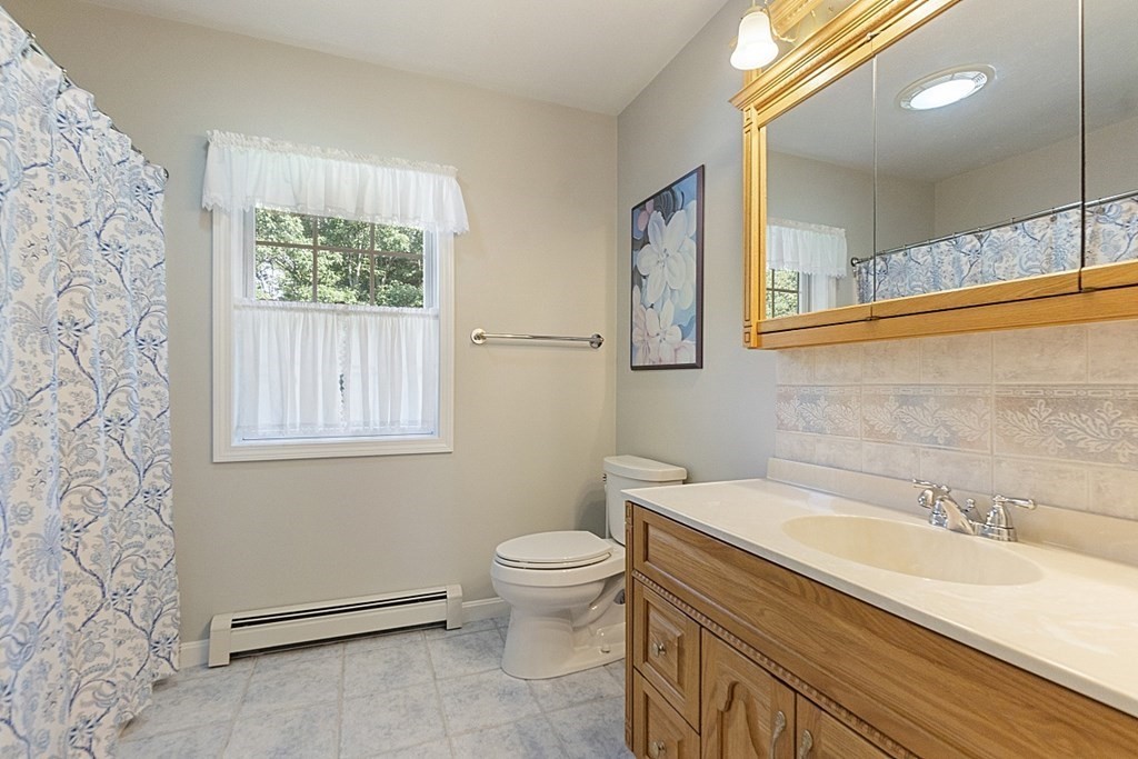 71 Easter Brook Road Lunenburg, MA 01462 - Photo 26 of 33 a bathroom with a granite countertop sink mirror vanity and toilet