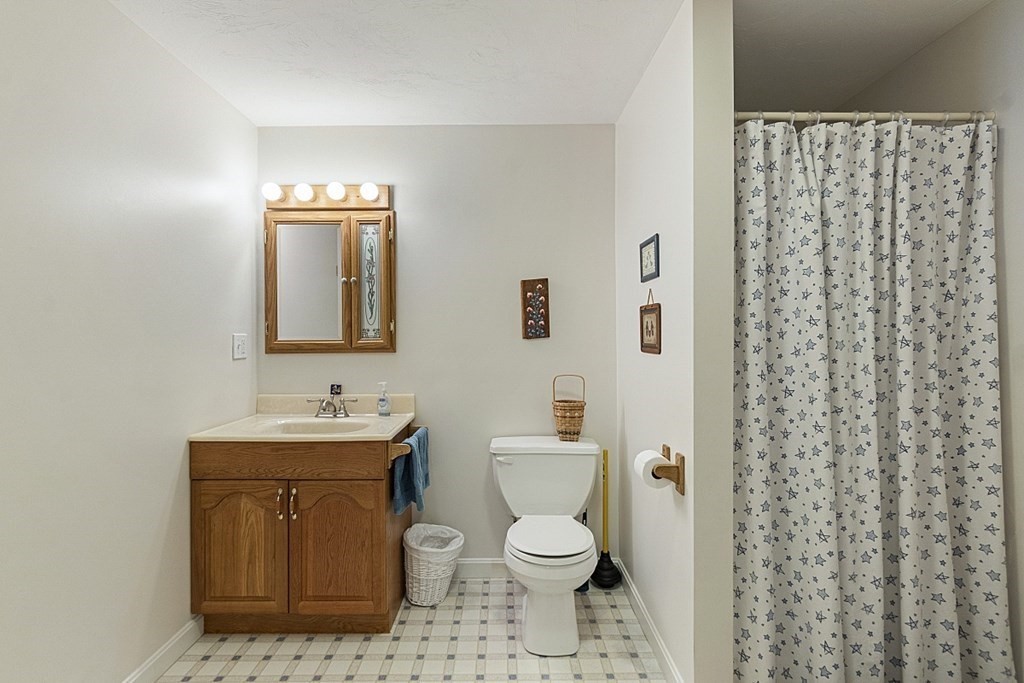 71 Easter Brook Road Lunenburg, MA 01462 - Photo 33 of 33 a bathroom with a toilet a sink and mirror