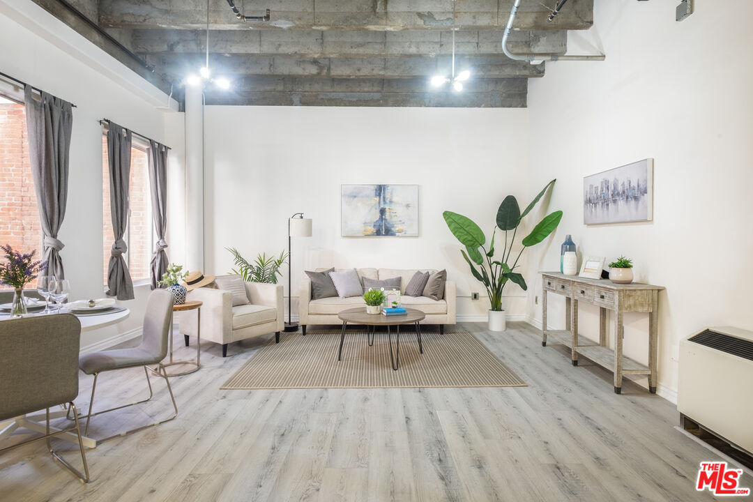 312 West 5th Street, Unit 606 Los Angeles, CA 90013 - Photo 1 of 18 a living room with furniture and a large window