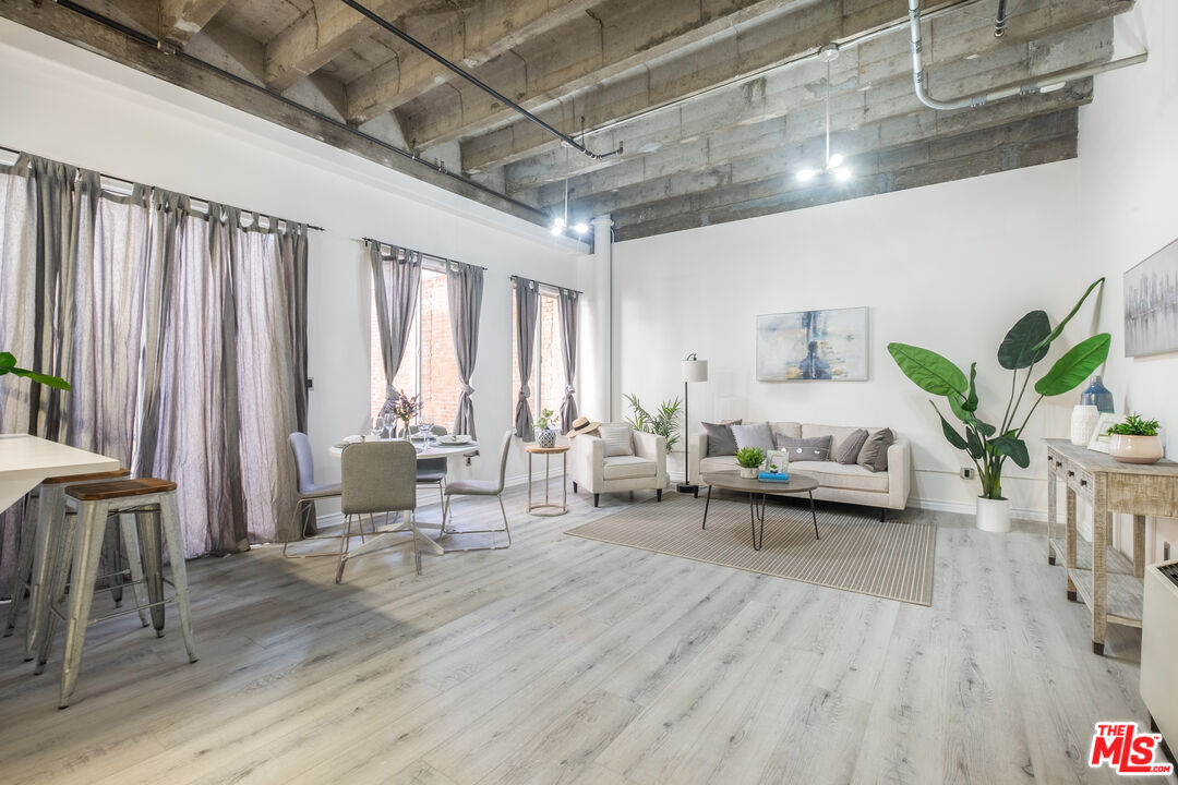 312 West 5th Street, Unit 606 Los Angeles, CA 90013 - Photo 4 of 18 a living room with furniture and wooden floor