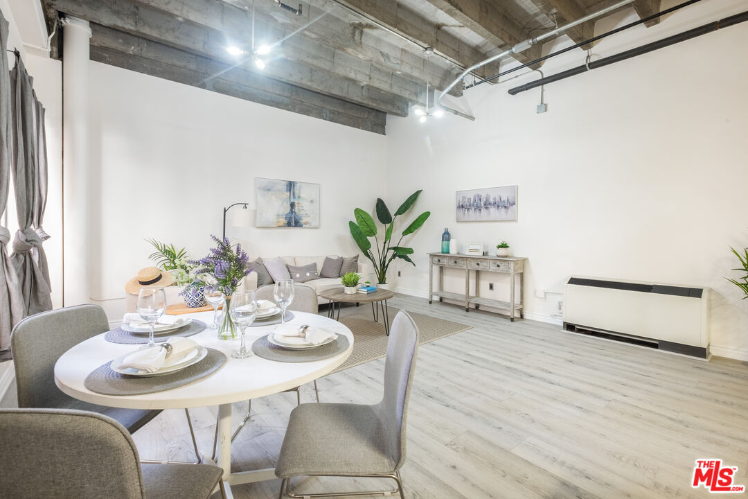 312 West 5th Street, Unit 606 Los Angeles, CA 90013 - Photo 5 of 18 a dining room with furniture and wooden floor