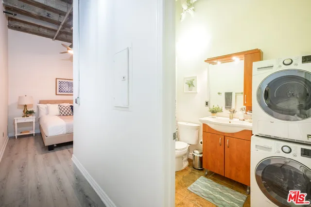 a view of a bedroom with washer and dryer