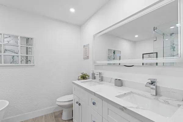 a bathroom with a toilet sink and mirror