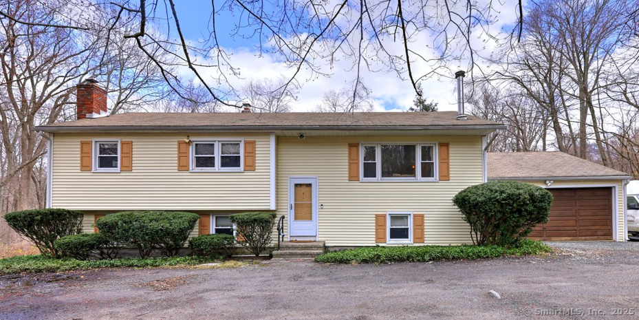 a house that has a tree in front of the house