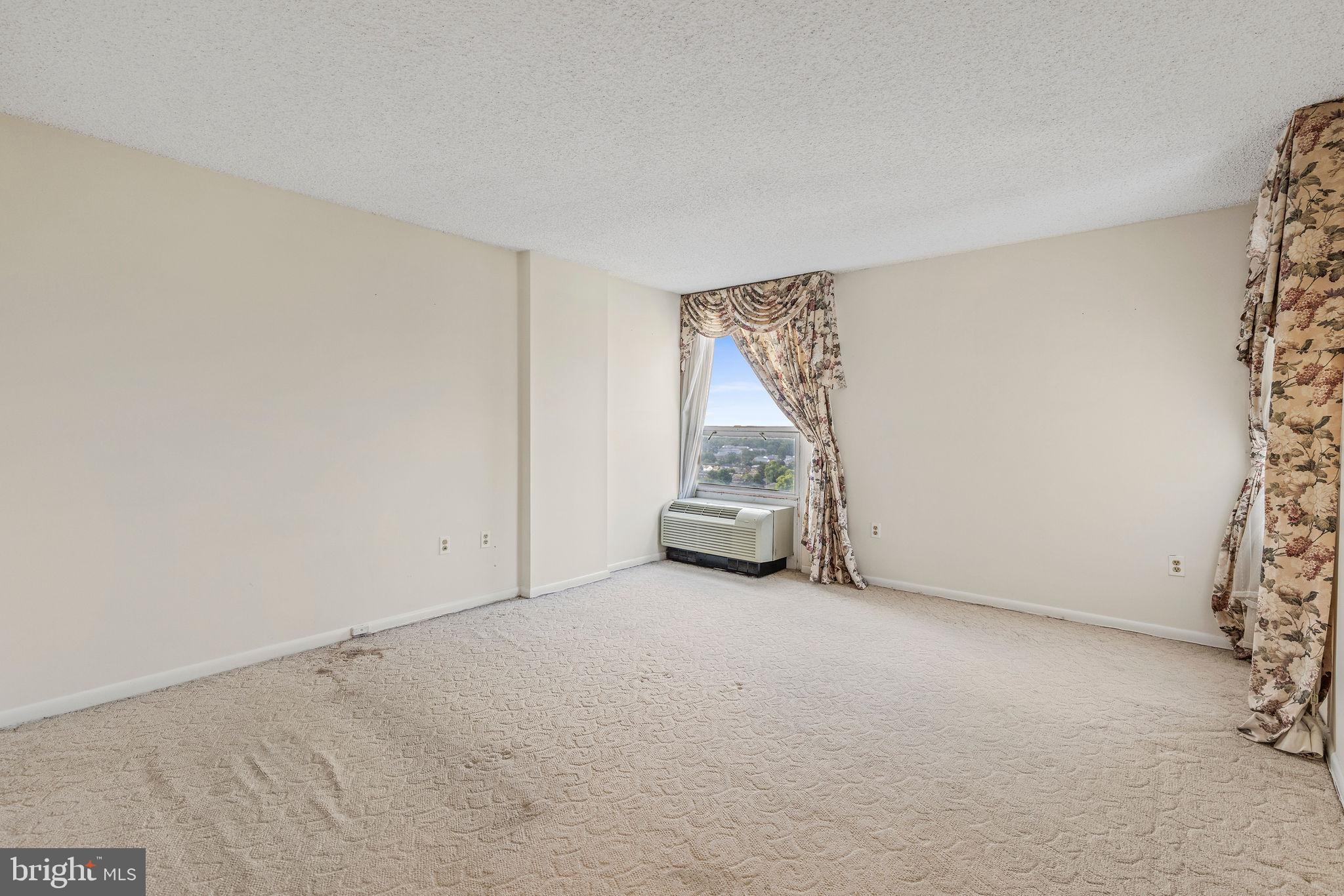 205 East Joppa Road, Unit 1606 Towson, MD 21286 - Photo 14 of 33 an empty room with furniture and a window