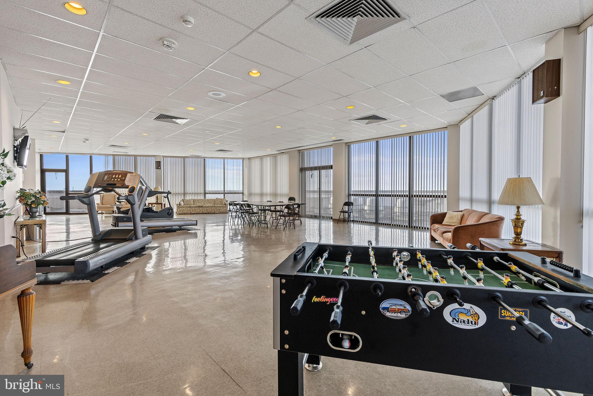 205 East Joppa Road, Unit 1606 Towson, MD 21286 - Photo 32 of 33 a kitchen with a stove a refrigerator and a dining table with wooden floor