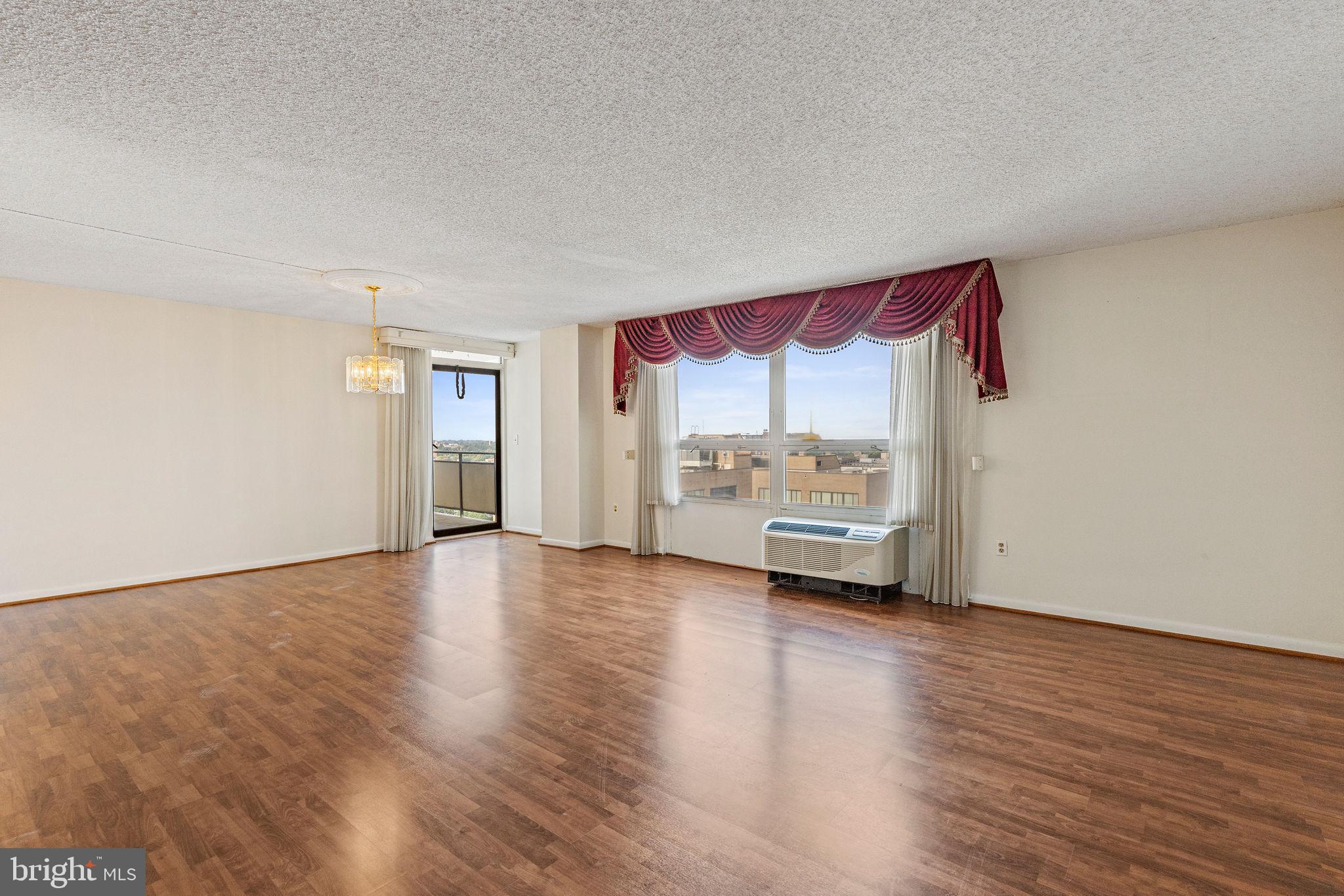 205 East Joppa Road, Unit 1606 Towson, MD 21286 - Photo 7 of 33 a view of an empty room with a window and wooden floor
