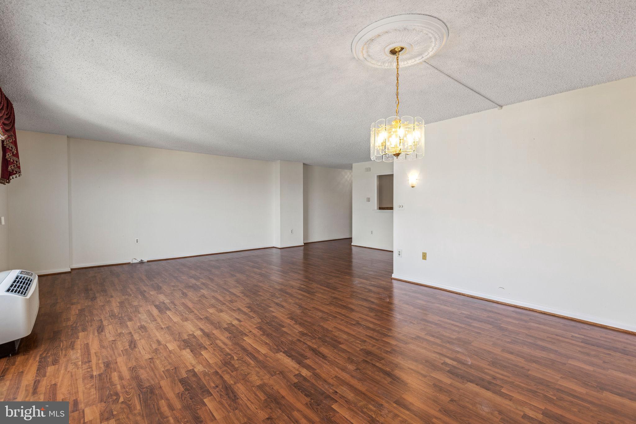 205 East Joppa Road, Unit 1606 Towson, MD 21286 - Photo 8 of 33 a view of empty room with wooden floor and ceiling fan