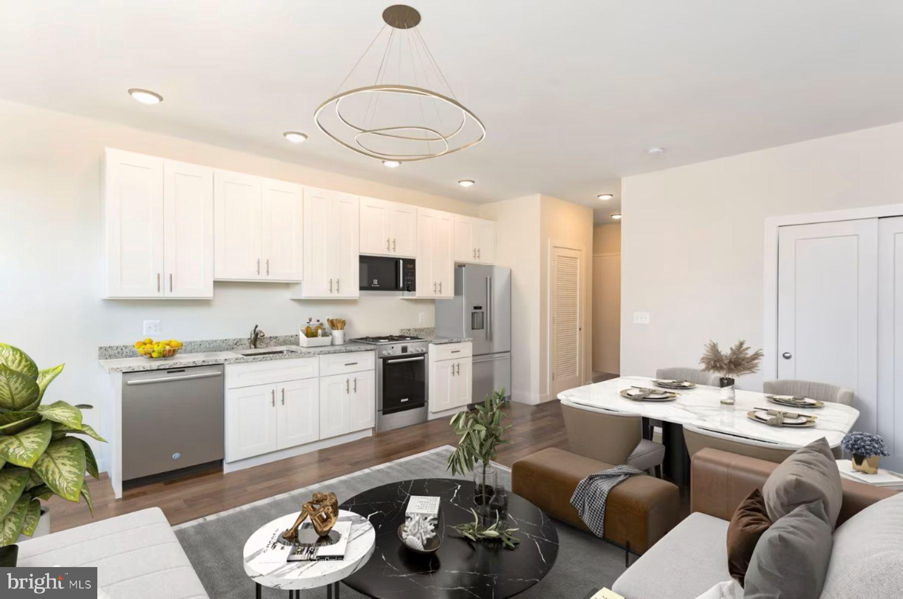 a living room with stainless steel appliances kitchen island granite countertop a stove a sink dishwasher and white cabinets with wooden floor