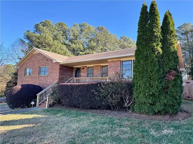 a front view of a house with a garden