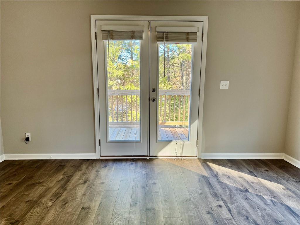30 Shallowford Road Northeast Kennesaw, GA 30144 - Photo 17 of 41 an empty room with wooden floor and windows