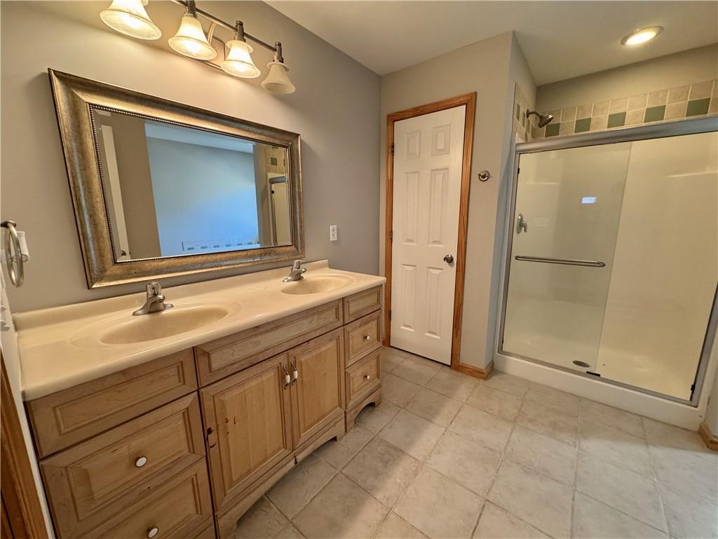 30 Shallowford Road Northeast Kennesaw, GA 30144 - Photo 19 of 41 a bathroom with a double vanity sink mirror and shower