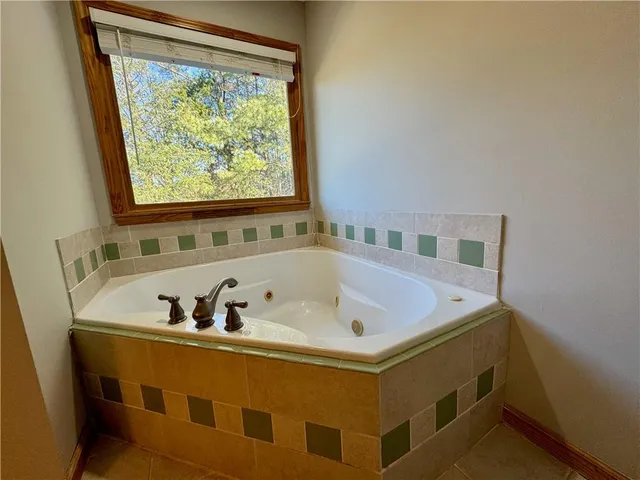 a bathroom with a granite countertop double vanity and a mirror