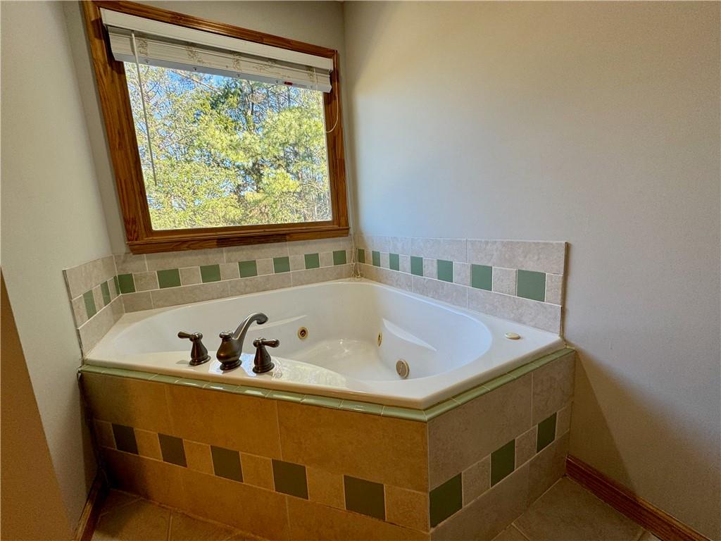 30 Shallowford Road Northeast Kennesaw, GA 30144 - Photo 21 of 41 a bath tub sitting in a bathroom next to a window