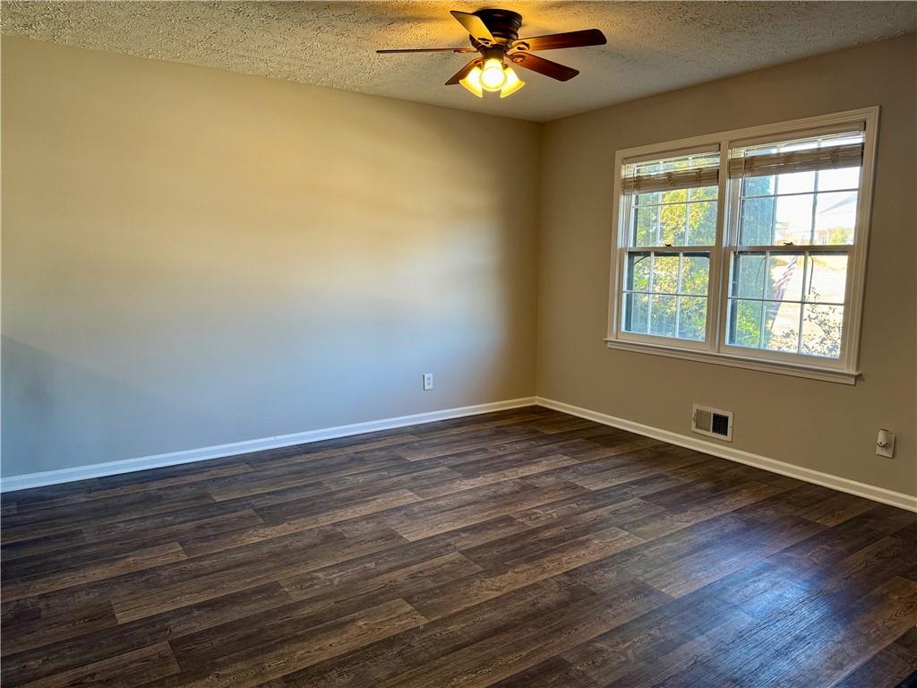 30 Shallowford Road Northeast Kennesaw, GA 30144 - Photo 26 of 41 a view of an empty room with wooden floor and a window