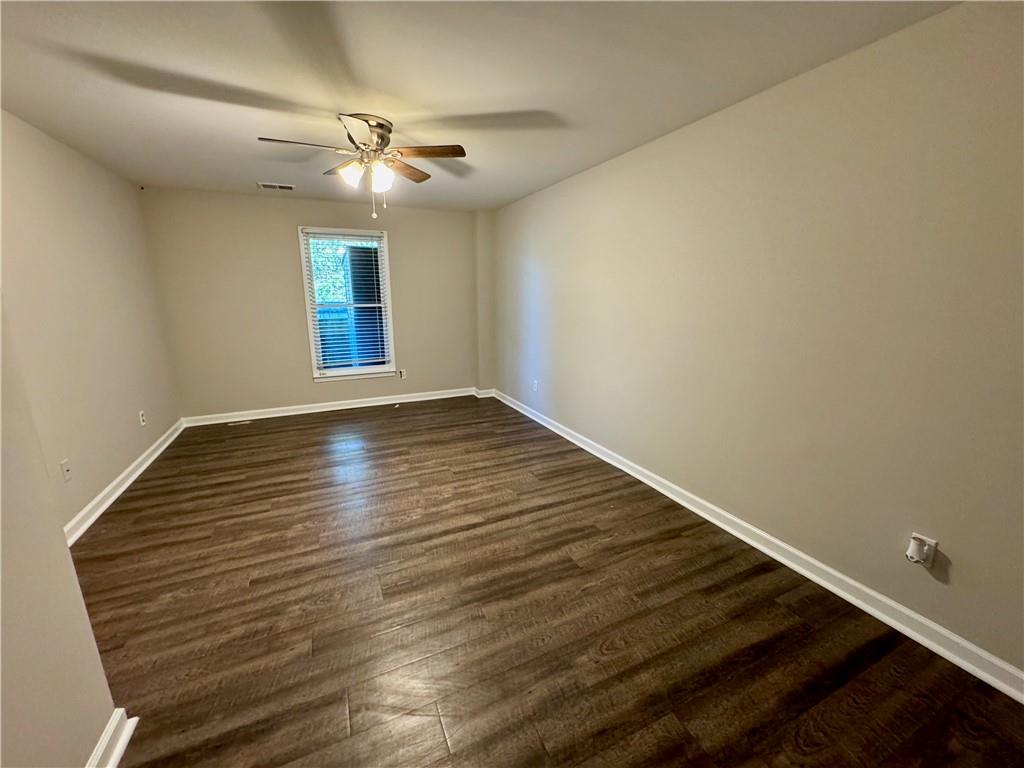 30 Shallowford Road Northeast Kennesaw, GA 30144 - Photo 27 of 41 a view of an empty room with window and wooden floor