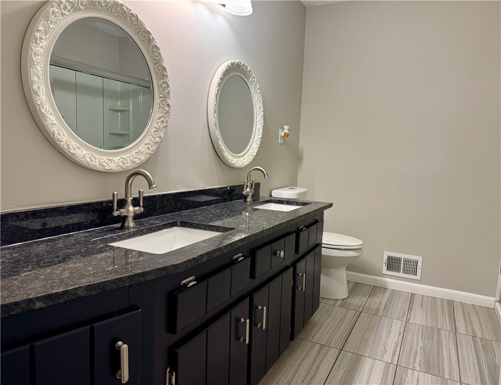 30 Shallowford Road Northeast Kennesaw, GA 30144 - Photo 29 of 41 a bathroom with a granite countertop double vanity and a mirror
