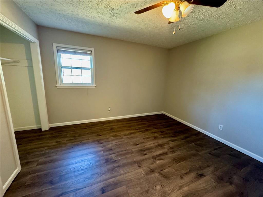 30 Shallowford Road Northeast Kennesaw, GA 30144 - Photo 31 of 41 a view of an empty room with wooden floor and a window