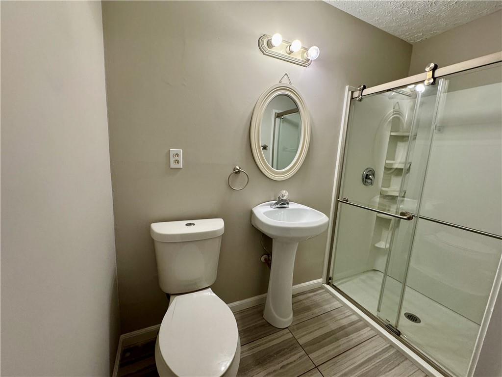 30 Shallowford Road Northeast Kennesaw, GA 30144 - Photo 37 of 41 a bathroom with a sink toilet and a shower