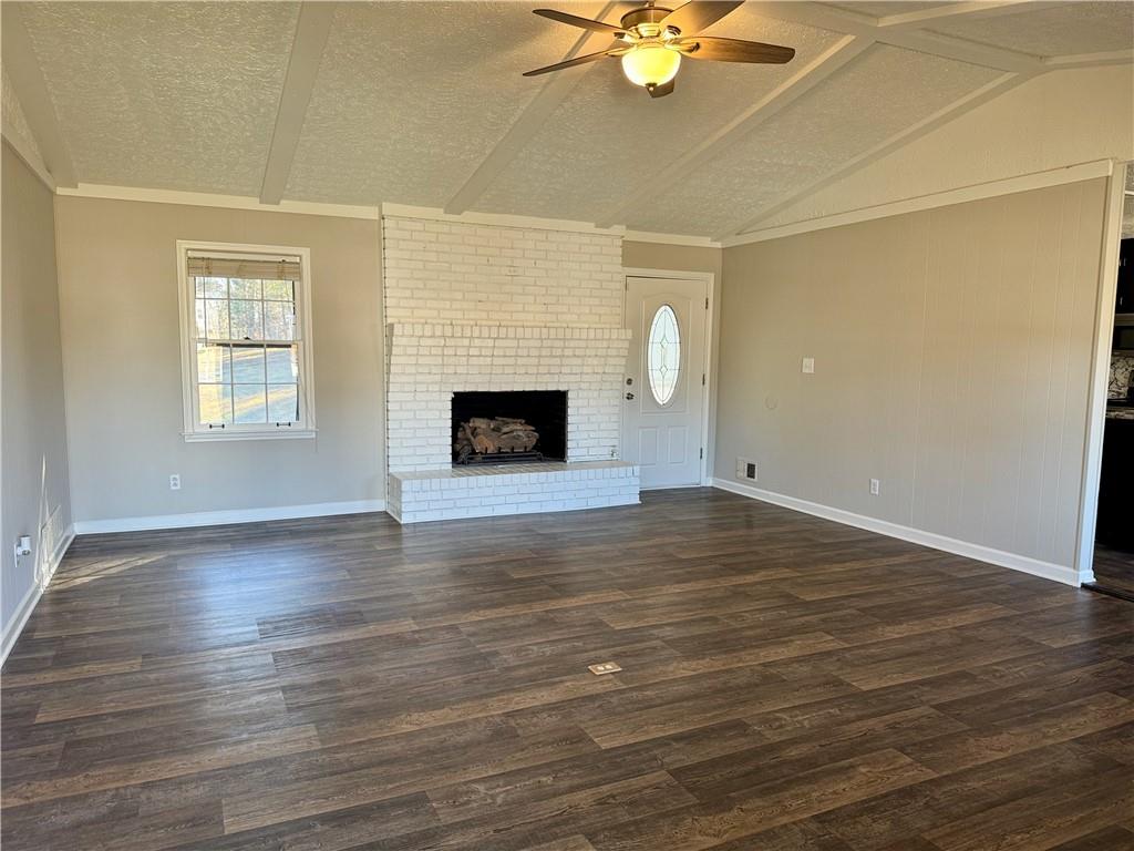30 Shallowford Road Northeast Kennesaw, GA 30144 - Photo 6 of 41 an empty room with wooden floor fan and windows