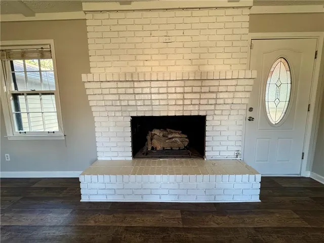 a kitchen with granite countertop stove top oven microwave and cabinets