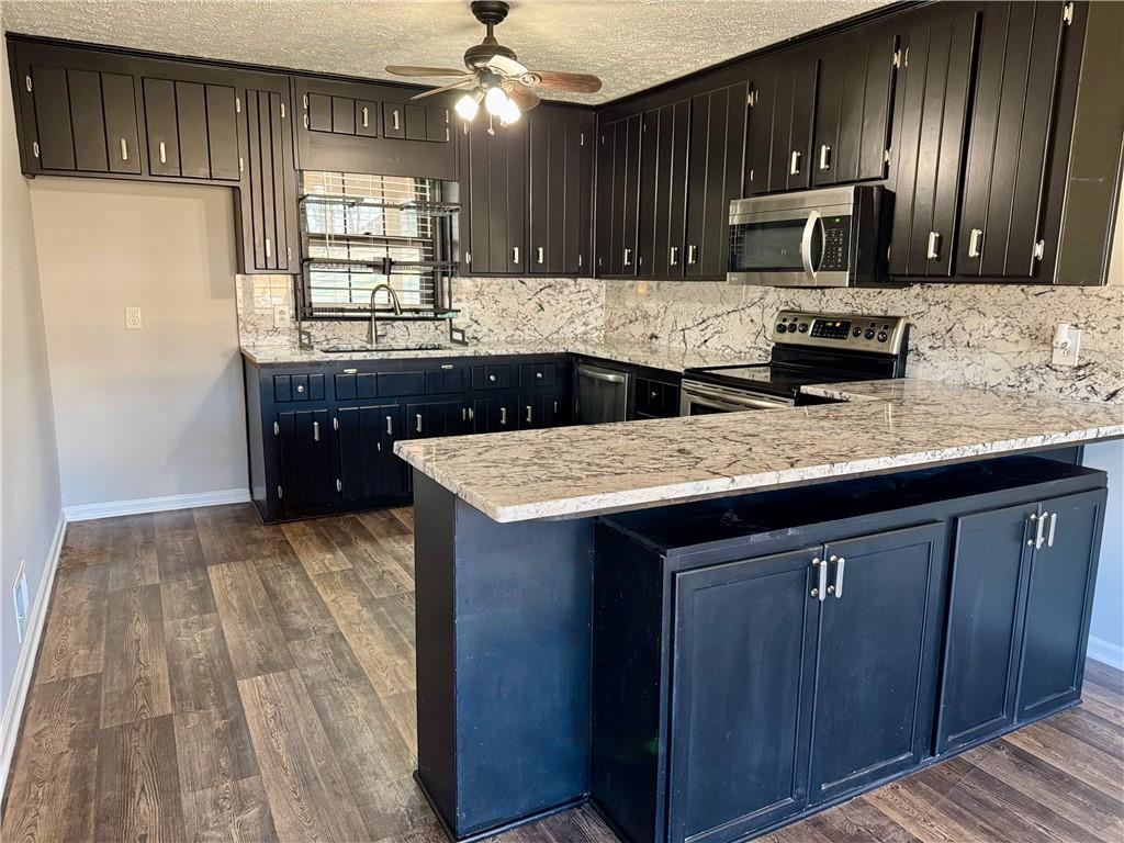 30 Shallowford Road Northeast Kennesaw, GA 30144 - Photo 9 of 41 a kitchen with a sink and a refrigerator
