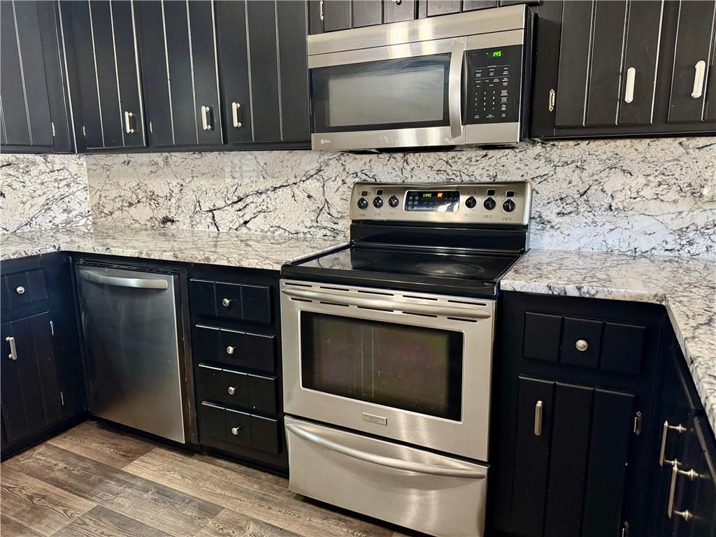 30 Shallowford Road Northeast Kennesaw, GA 30144 - Photo 10 of 41 a kitchen with granite countertop stove top oven microwave and cabinets