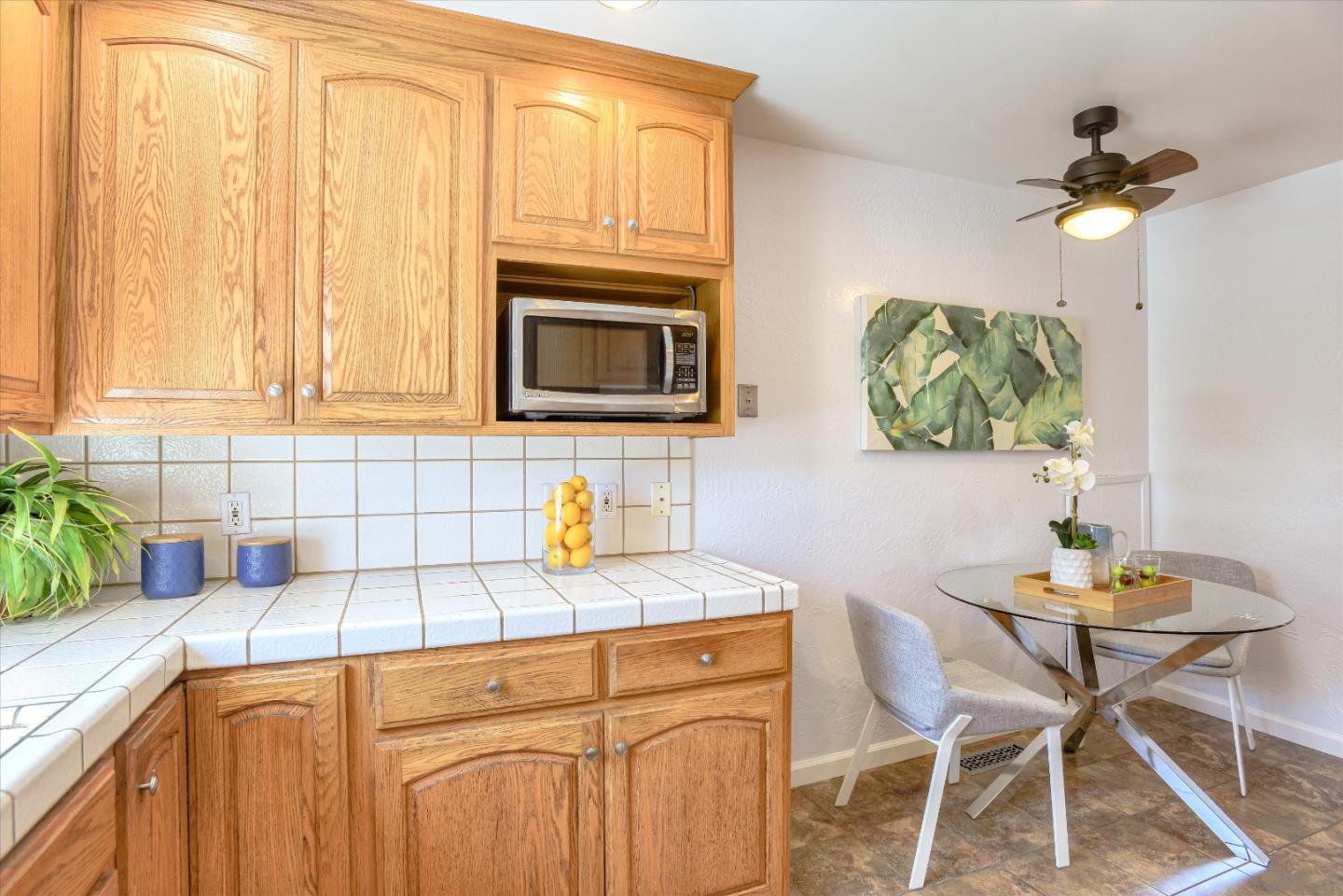 1619 Echo Avenue San Mateo, CA 94401 - Photo 12 of 34 a kitchen with stainless steel appliances granite countertop a sink a microwave cabinets and wooden floor