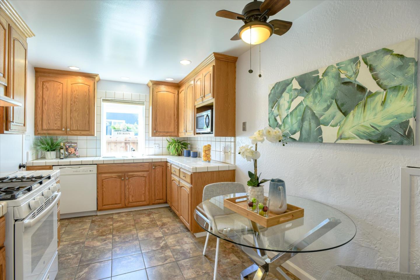 1619 Echo Avenue San Mateo, CA 94401 - Photo 16 of 34 a kitchen with stainless steel appliances granite countertop a sink a stove a dining table and chairs with wooden floor