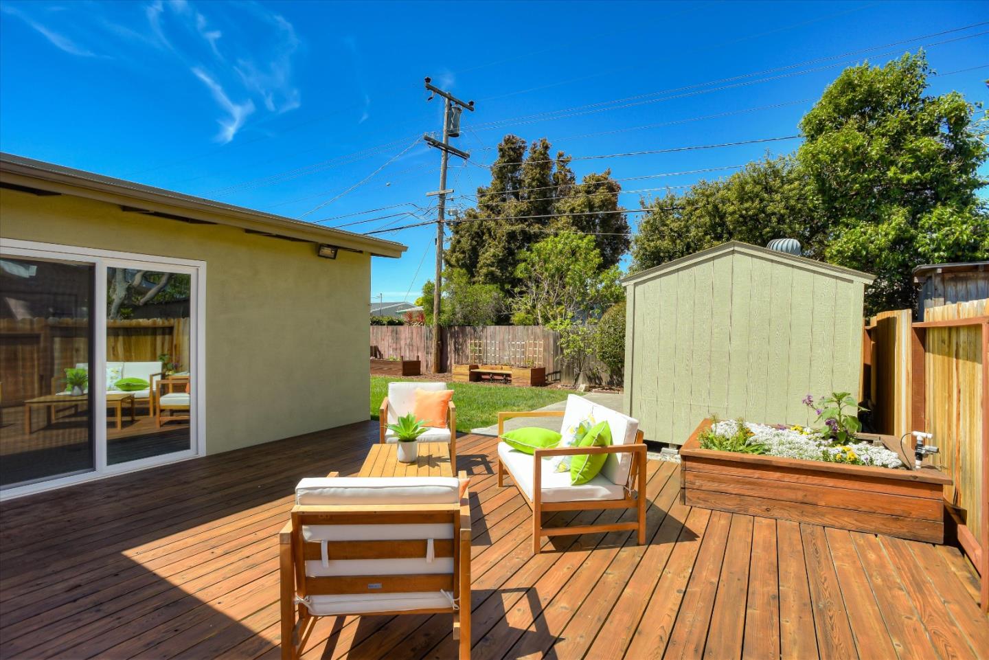 1619 Echo Avenue San Mateo, CA 94401 - Photo 29 of 34 a view of a patio with couches table and chairs with wooden floor and fence