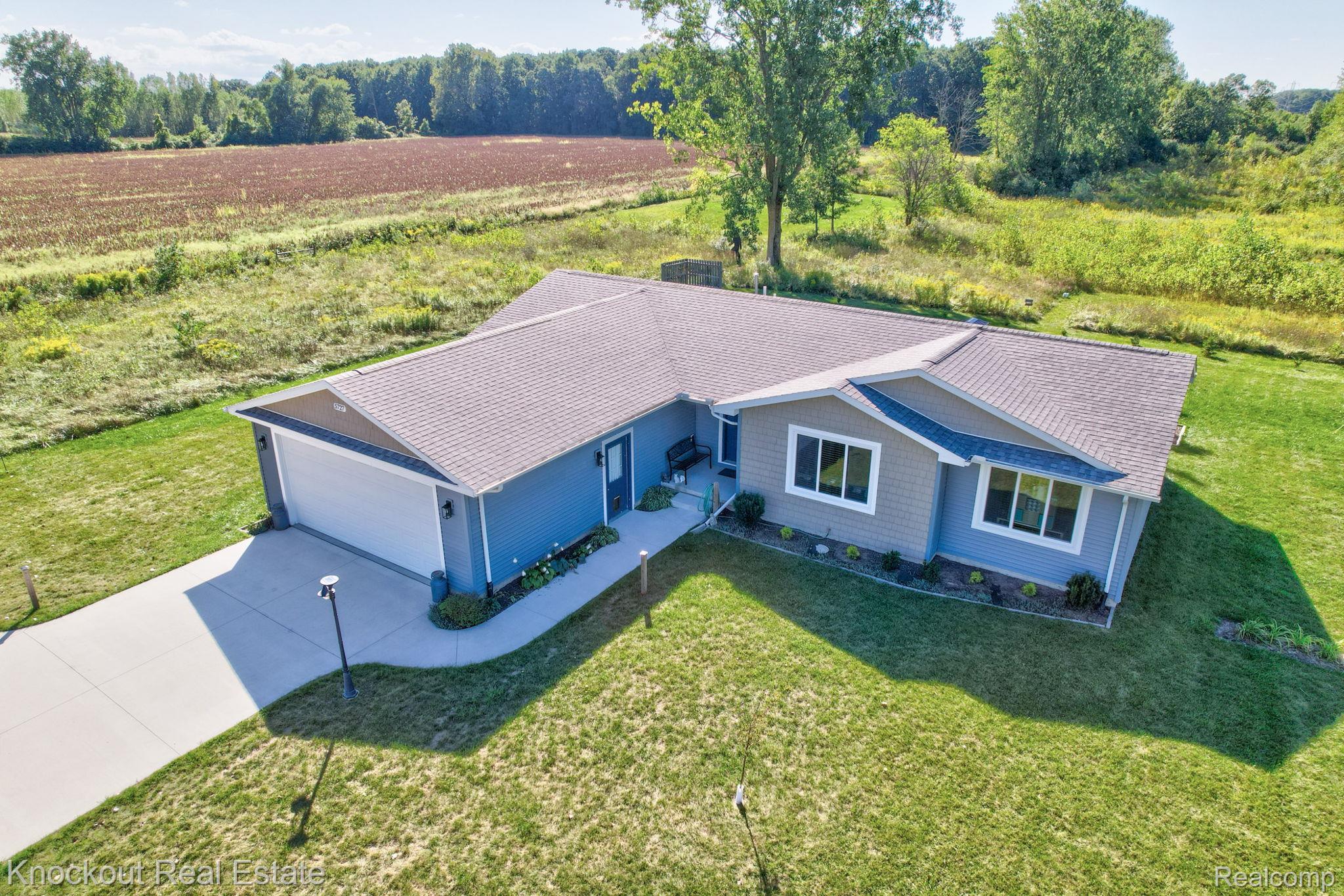 5727 Mackinaw Road Saginaw, MI 48604 - Photo 44 of 60 Contemporary ranch-style residence featuring a prominent front-facing garage, a concrete driveway, and a well-maintained lawn