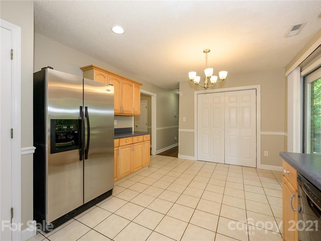 513 West Rebound Road Lancaster, SC 29720 - Photo 11 of 31 a view of a refrigerator in kitchen and an empty room with windows