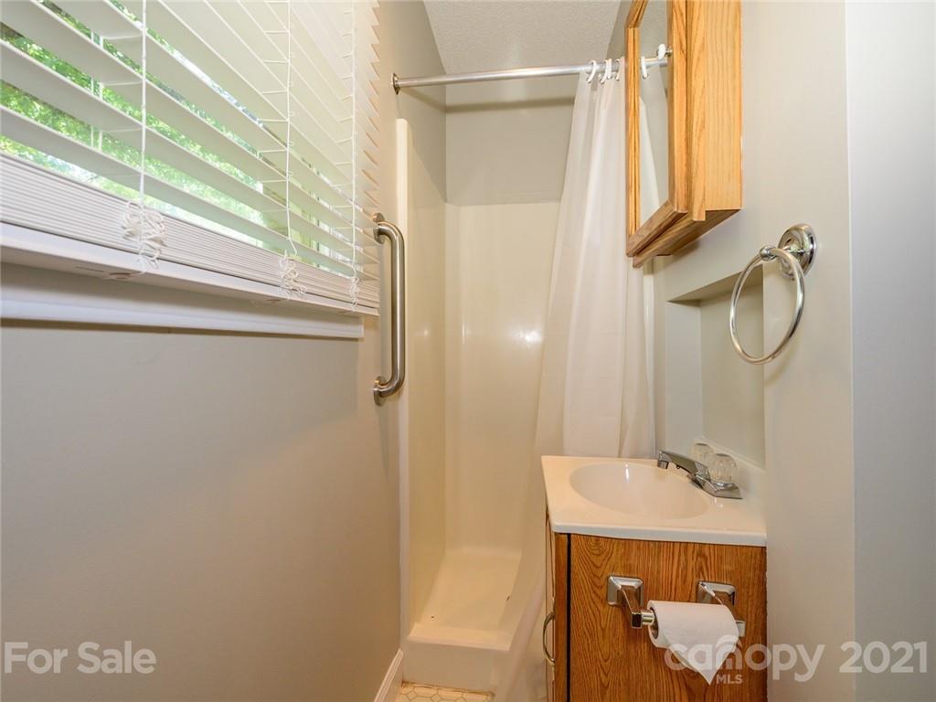 513 West Rebound Road Lancaster, SC 29720 - Photo 18 of 31 a bathroom with a sink a mirror and a shower