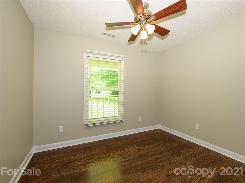 513 West Rebound Road Lancaster, SC 29720 - Photo 19 of 31 an empty room with wooden floor fan and windows