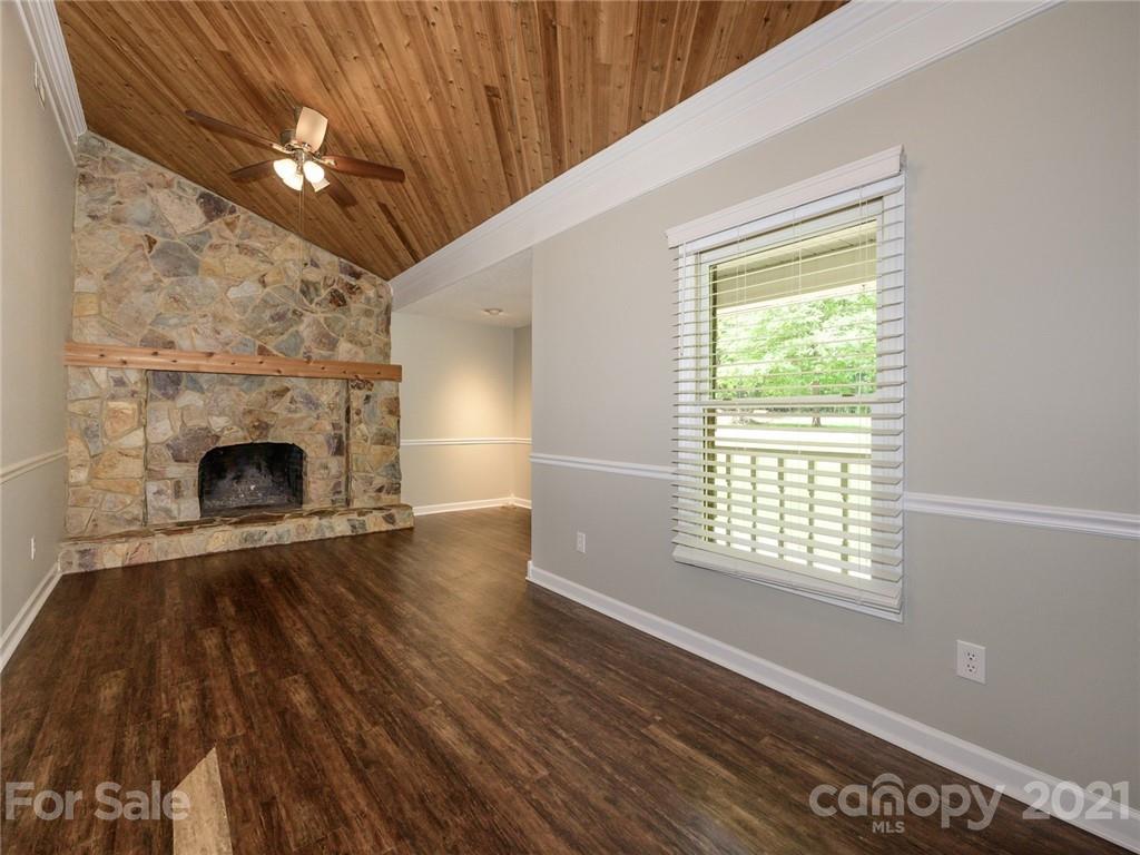 513 West Rebound Road Lancaster, SC 29720 - Photo 3 of 31 a view of an empty room with wooden floor fireplace and a window