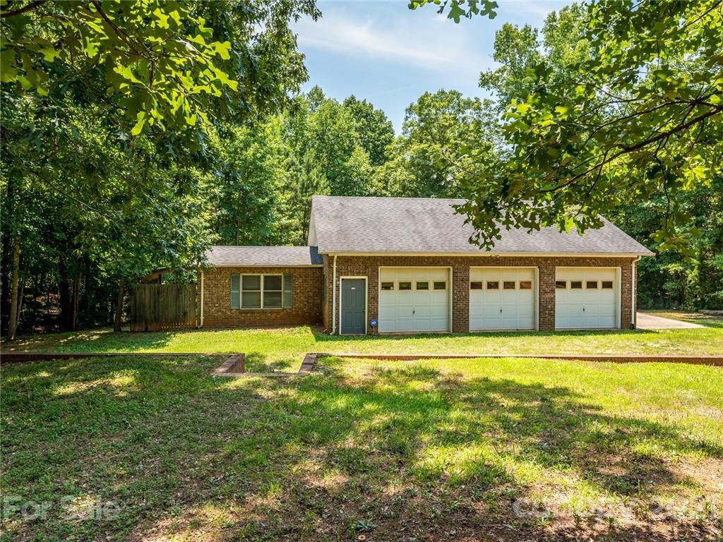 513 West Rebound Road Lancaster, SC 29720 - Photo 26 of 31 a front view of a house with a yard and trees