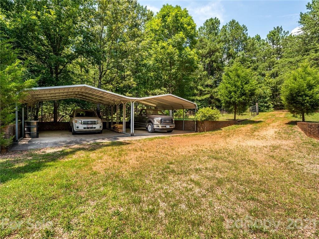 513 West Rebound Road Lancaster, SC 29720 - Photo 29 of 31 a view of swimming pool with lawn chairs and large trees