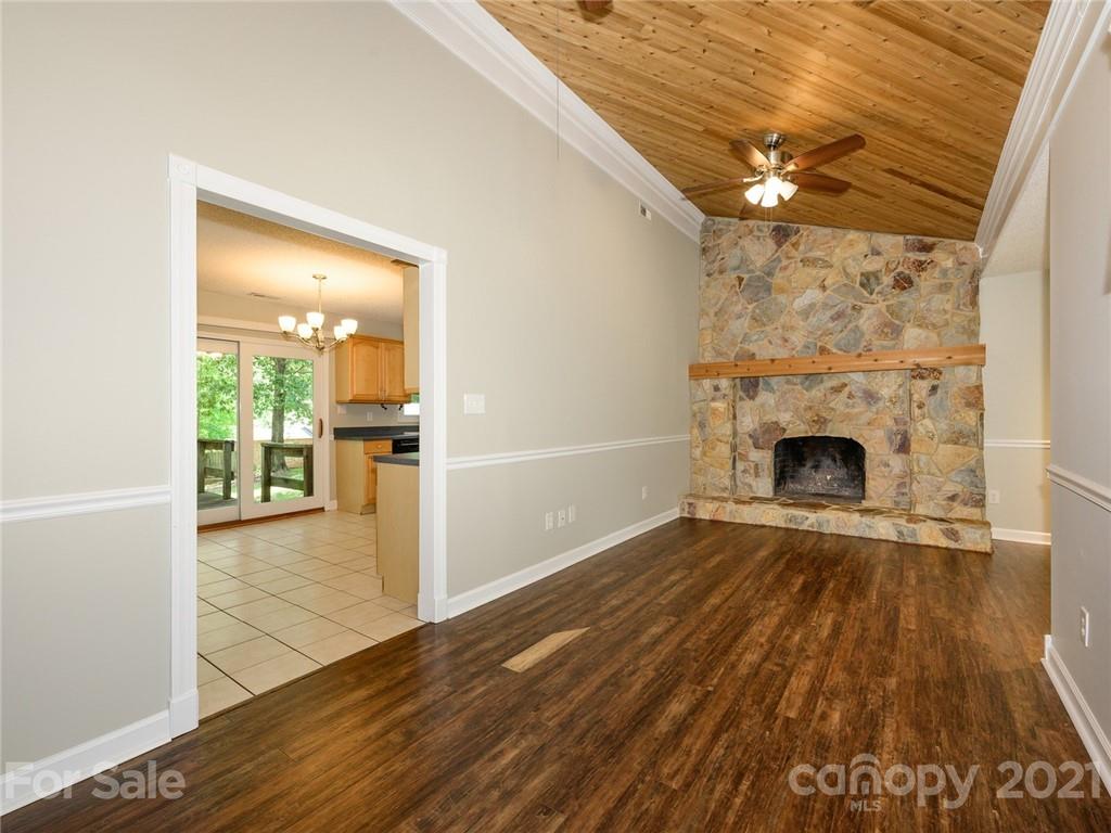 513 West Rebound Road Lancaster, SC 29720 - Photo 4 of 31 a view of a livingroom with wooden floor and a fireplace